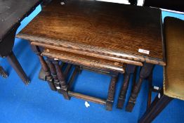 A traditional oak nest of three tables