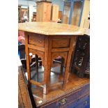 An Eastern style octagonal table with folding frame and brass inlay decoration