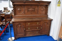 A late Victorian Gillow's of Lancaster oak sideboard, with raised and panelled back with barley