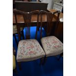 A pair of Edwardian mahogany dining chairs having inlaid feather backs