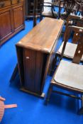 An early 20th Century oak drop leaf dining table