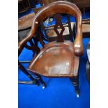 A 19th Century mahogany solid seat office armchair having turned legs and pot castors