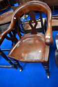 A 19th Century mahogany solid seat office armchair having turned legs and pot castors