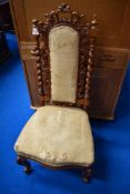 A 19th Century mahogany hall chair having mahogany twist and scroll frame with upholstered back