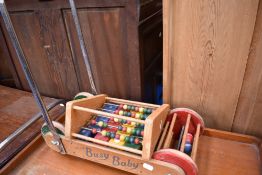 A vintage pushalong toy 'busy baby' and an abacus