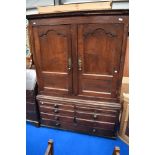 An 18th Century and later oak linen press/wardrobe with faux bottom and drawers, with just two short