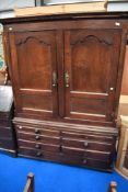 An 18th Century and later oak linen press/wardrobe with faux bottom and drawers, with just two short