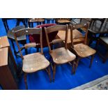 A set of three Victorian stained frame kitchen chairs having rail backs