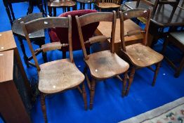 A set of three Victorian stained frame kitchen chairs having rail backs