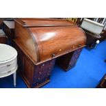 A Victorian mahogany cylinder roll top bureau desk with fitted interior and double drawer pedestals,