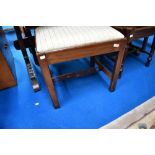 A 19th Century mahogany dressing table stool having later upholstered seat