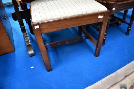 A 19th Century mahogany dressing table stool having later upholstered seat