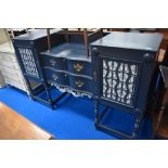 A painted sideboard having leopard themed papered panels