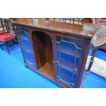 A reproduction Regency style low bookcase with open shelves to centre