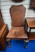 A early 20th Century dining chair having leather upholstery with studded edge, on cabriole legs with