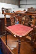 An Edwardian mahogany corner salon chair