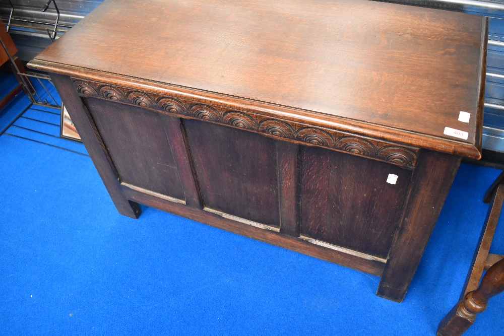 An early 20th Century oak three panelled kist bedding box of small proportions
