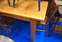 A traditional pine kitchen table having chunky square legs
