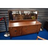 A vintage Remploy dressing table having three long drawers and cupboard to base