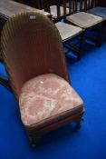A vintage Lloyd Loom nursing chair