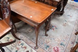 An early 20th Century occasional table on cabriole legs
