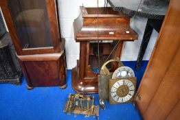 A selection of long case clock parts including figured mahogany case, faces , pendulums and