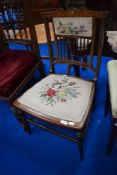 An Edwardian mahogany and inlaid bedroom chair having tapestry seat and spindle back