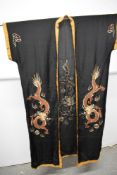 An early 20th century silk kimono dressing gown with frog fastenings, embroidered with dragon