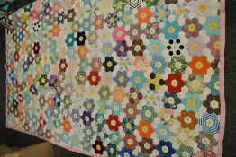A vintage Patchwork quilt, predominantly 1950s fabrics used.