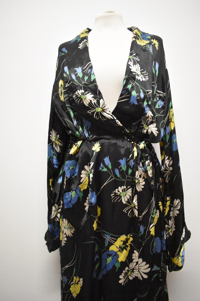 A 1940s glossy black rayon house coat, having vibrant floral pattern, very satin like to the touch. - Image 2 of 7