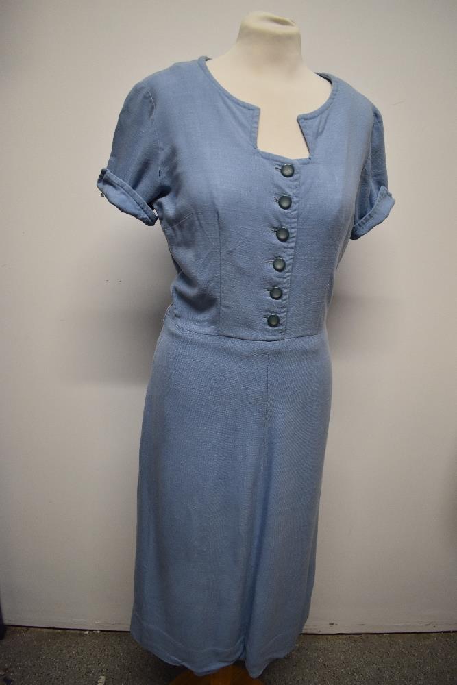 A simple, yet highly effective 1940s blue linen day dress, having side metal zip and button front