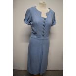 A simple, yet highly effective 1940s blue linen day dress, having side metal zip and button front