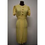 A late 1930s lemon linen day dress having scalloped detail to bodice and self covered buttons,