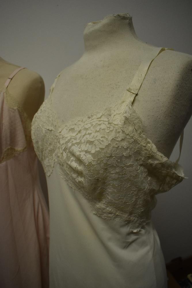 Five 1950s and 1960s sheer and semi sheer nylon slips, all having lace, medium to large sizes. - Image 7 of 12