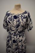 An early 1950s blue and white linen day dress having abstract floral pattern, belt to waist, short
