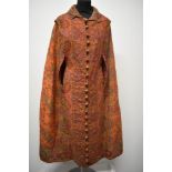 An interesting Victorian orange woven paisley cape, with the most intricately embroidered Paisley