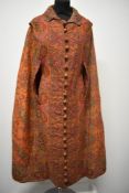 An interesting Victorian orange woven paisley cape, with the most intricately embroidered Paisley