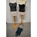 A 1940s boned black lace and blue crepe bustier, a 1960s strapless black lace bustier and a 1960s