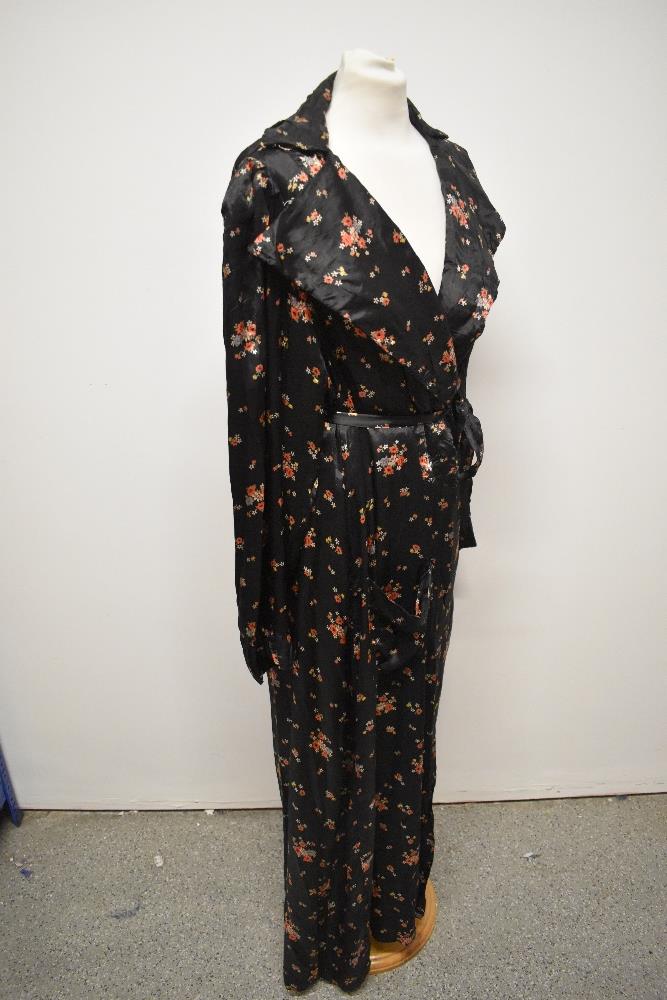 A late 1930s/1940s glossy black rayon house coat, having bright floral sprigs, pocket and dramatic - Image 6 of 7
