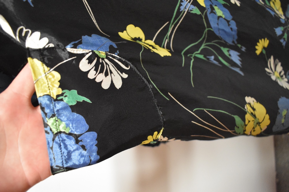 A 1940s glossy black rayon house coat, having vibrant floral pattern, very satin like to the touch. - Image 4 of 7