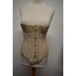 An early 20th century side sprung corset, having lace to top.