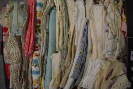 A box of vintage and antique table linen, including embroidered, coloured and lace edged items.