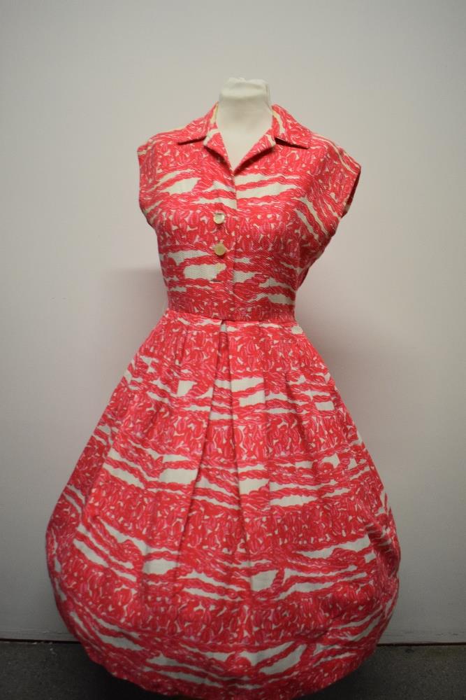 A 1950s medium weight textured cotton day dress, having side zip and fairly full pleated skirt