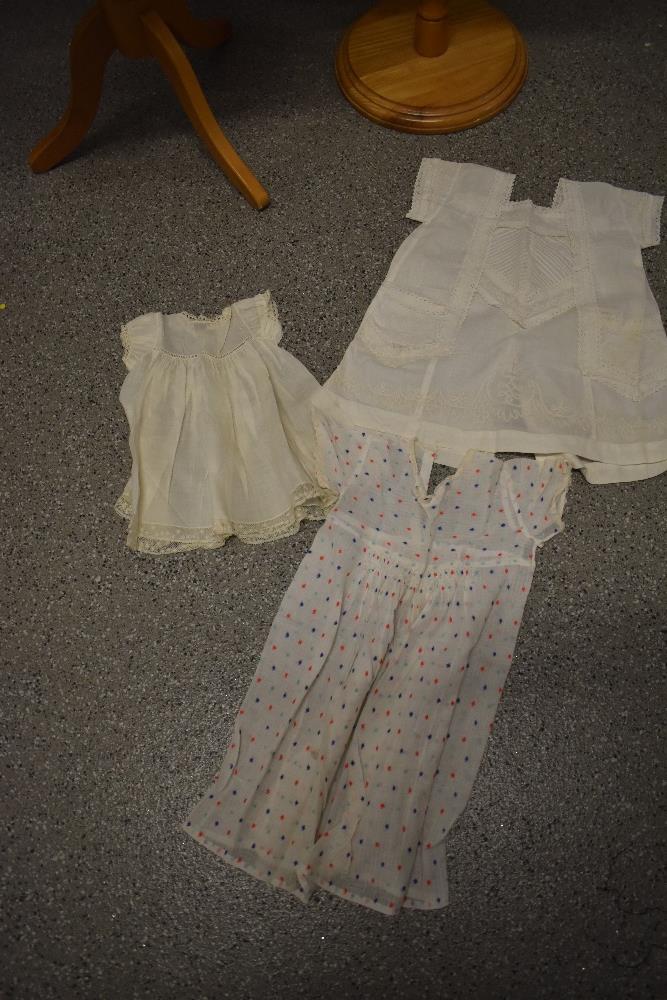 A mixed lot of childrens and babies clothing, including 1950s child's dress, 1970s blue dress and an - Image 2 of 7