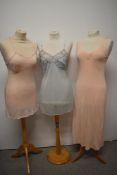 A 1950s sheer mesh slip, a pink 1930s/40s rayon slip and a 1940s nightdress with floral satin