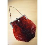 An early 20th century ombre red velvet evening bag, having white metal mount, with enamel and