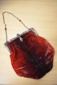 An early 20th century ombre red velvet evening bag, having white metal mount, with enamel and