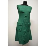 An early 1960s emerald green linen mini dress, having large self covered faux button detail to
