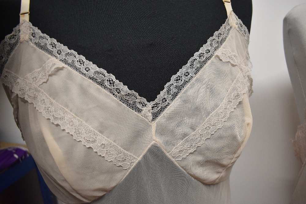 Five 1950s and 1960s sheer and semi sheer nylon slips, all having lace, medium to large sizes. - Image 5 of 12