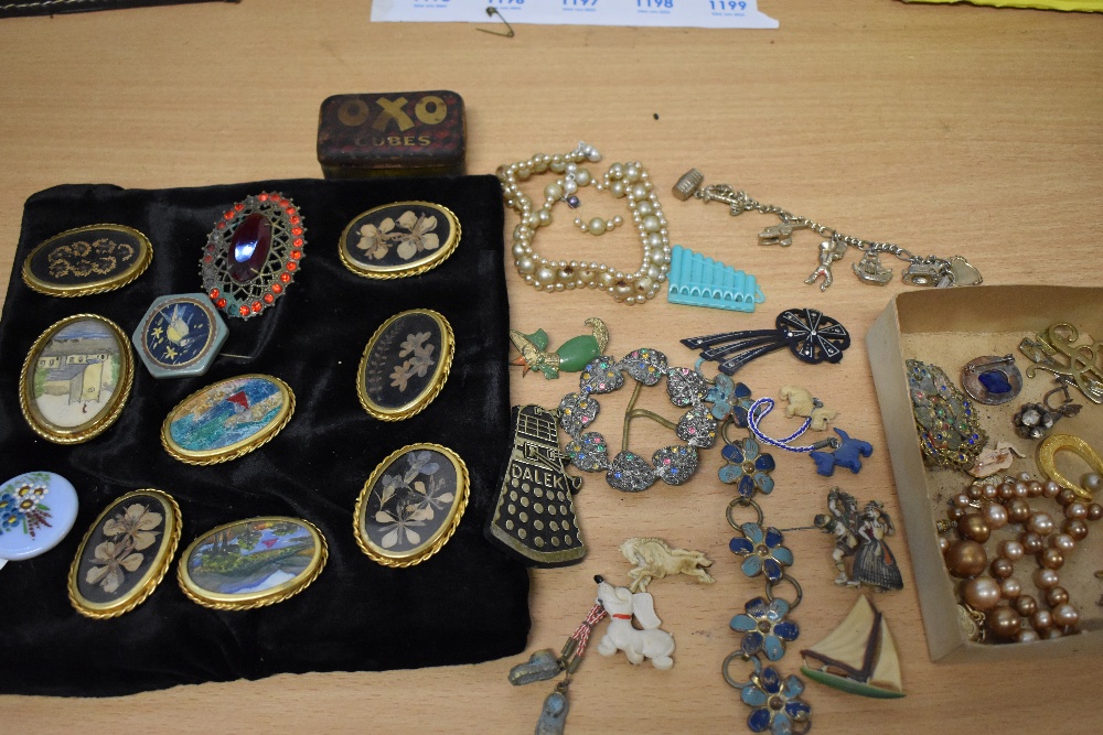 A mixed lot of vintage and antique jewellery, including charm bracelet and mid century novelty